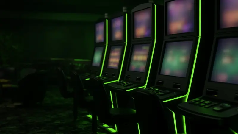 A dark row of slot cabinets sits beside the LakhBet notes on Mines.